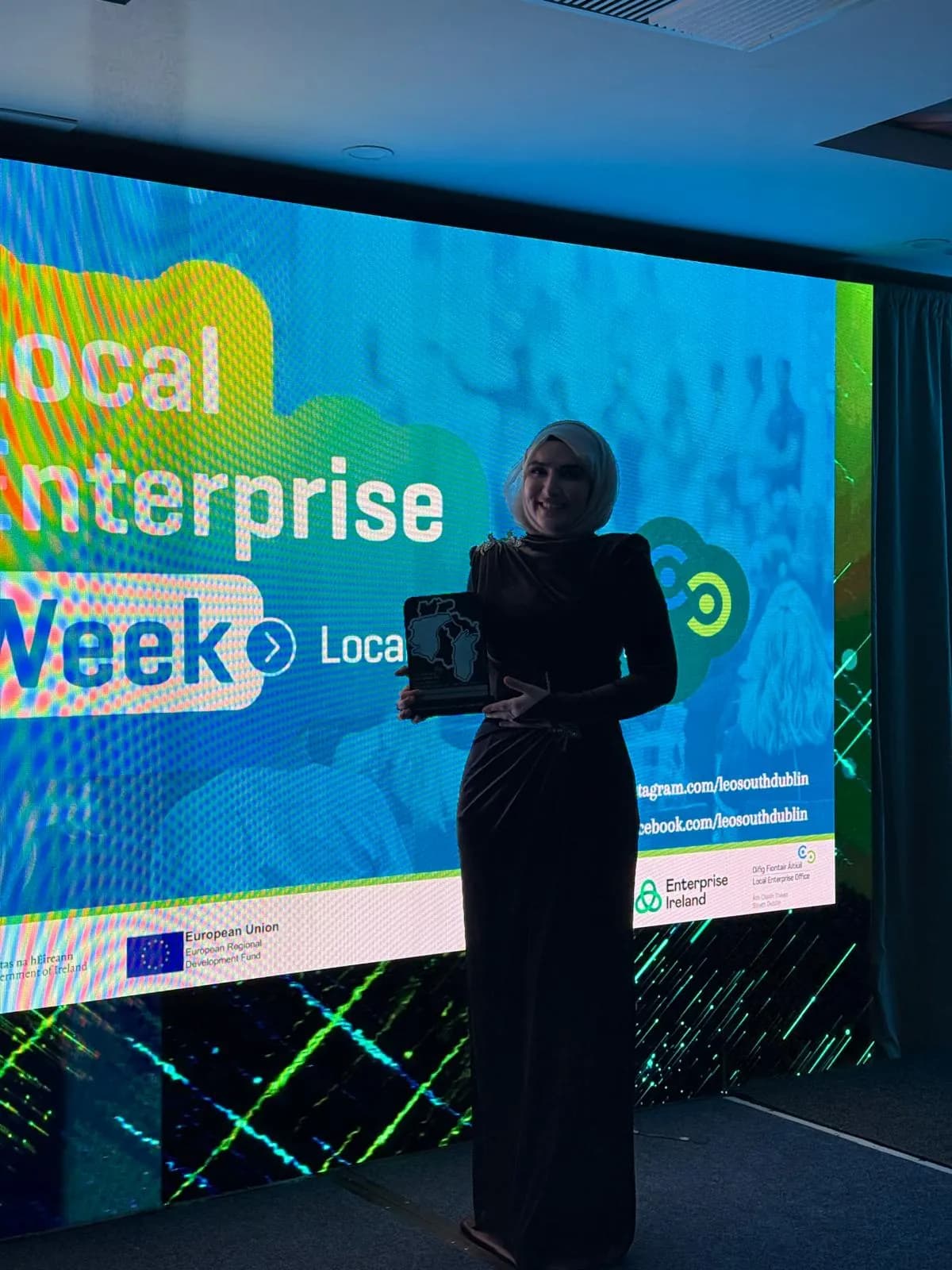 Dr. Elif Torun on stage in front of the Local Enterprise Week screen